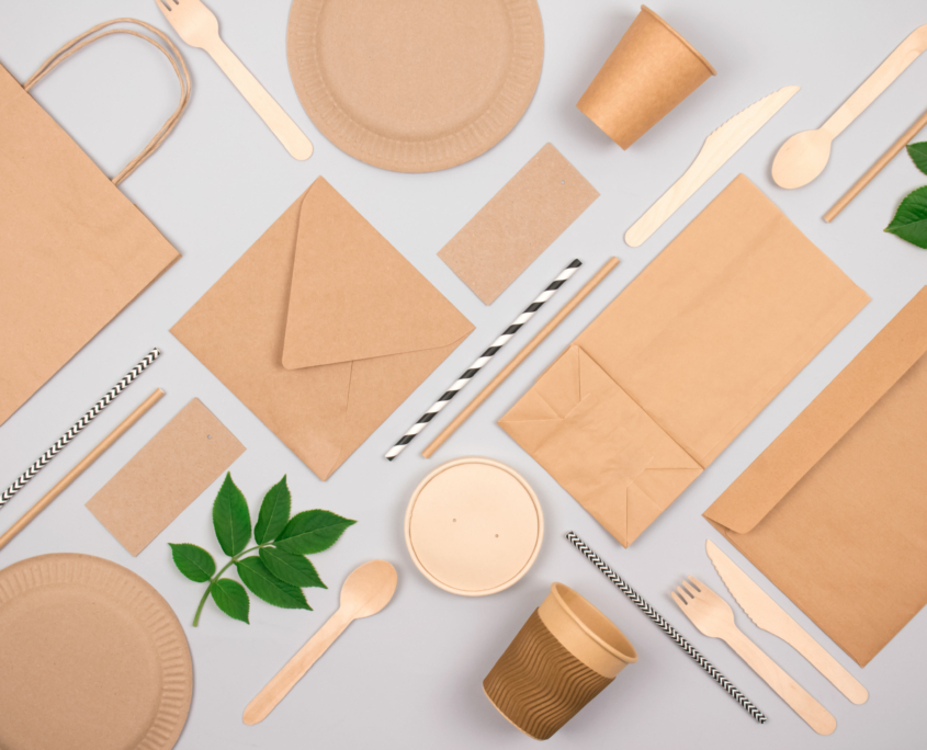Flat lay composition with eco-friendly tableware - kraft paper food packaging on light grey background. Street food paper packaging, recyclable paperware, zero waste packaging concept. Mockup